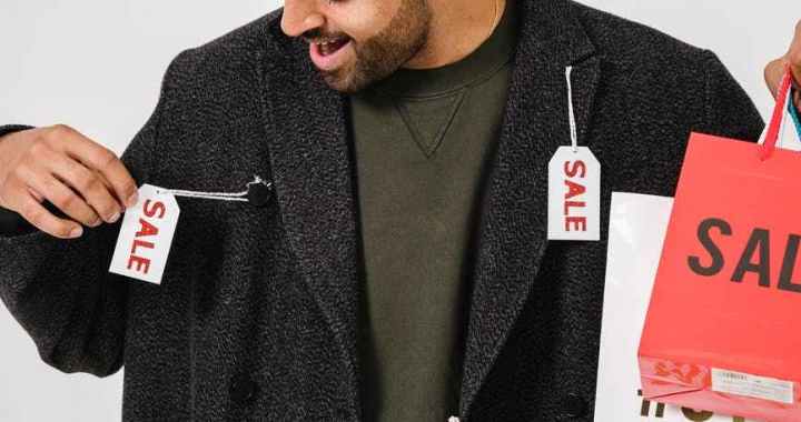 man in gray blazer with sale tags