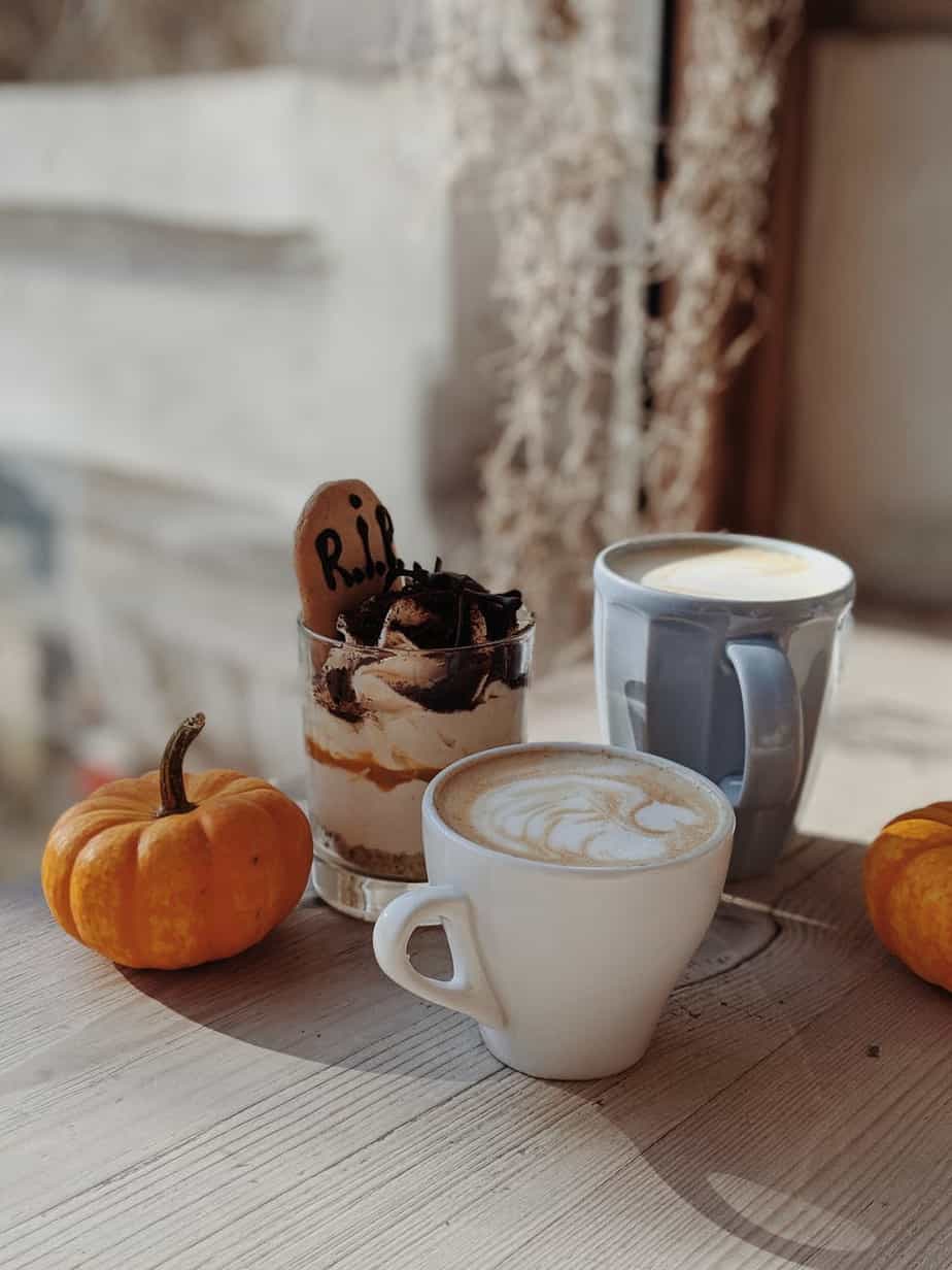 two white and blue mugs beside drinking glass